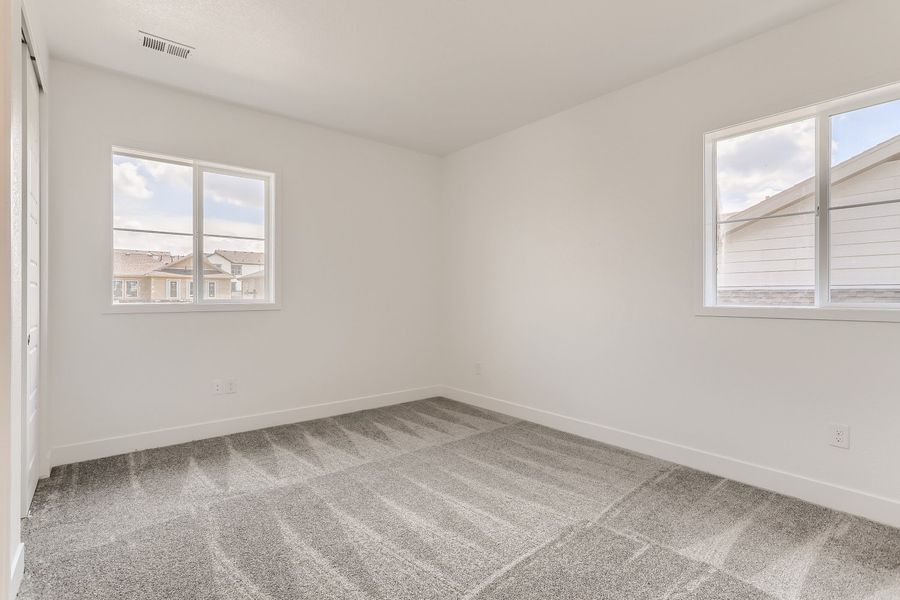 Upstairs secondary bedroom in Cornell II plan at The Outlook at Southshore by Century Communities