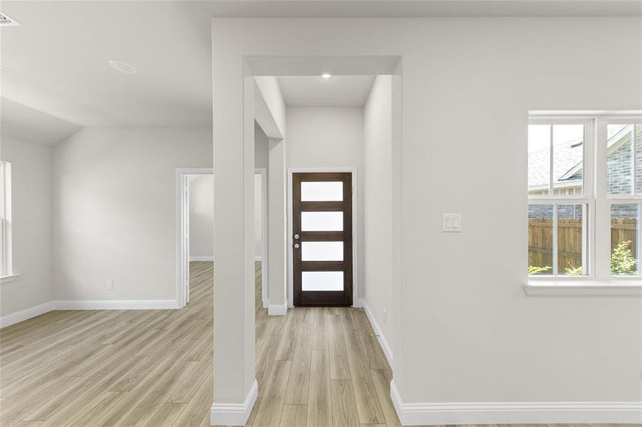 Entryway featuring a wealth of natural light and light hardwood / wood-style floors