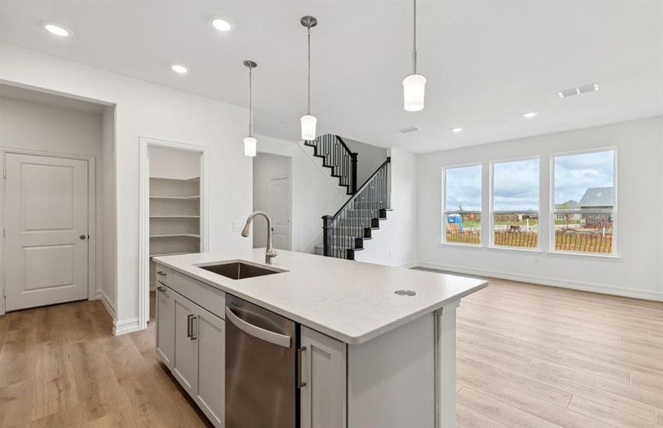 Large island overlooking gathering room and dining areas