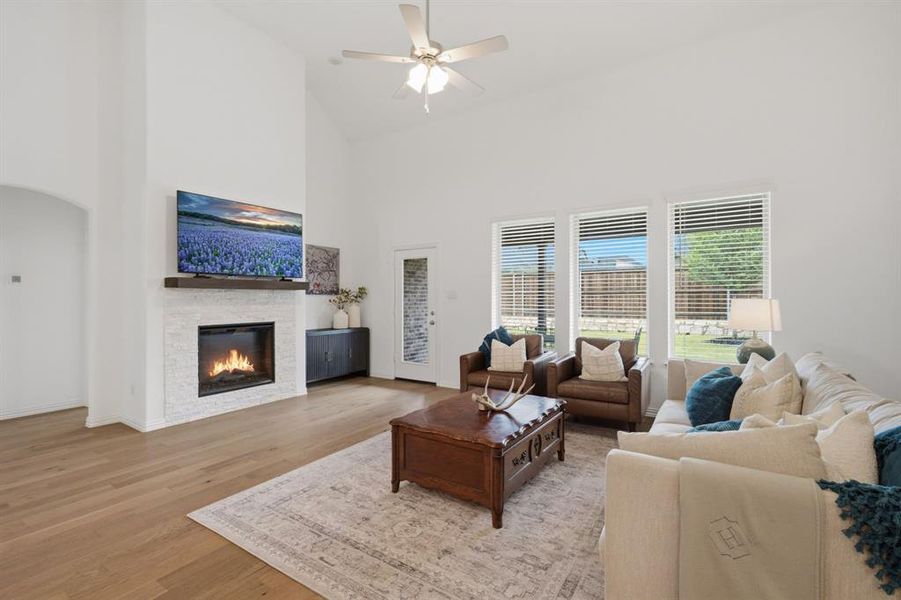 Soaring ceilings, a cozy fireplace, and walls of windows make this living room feel bright, spacious, and inviting. The open layout at 905 Bluebell St in Princeton, TX gives buyers the better-than-new home feel they want without the wait.