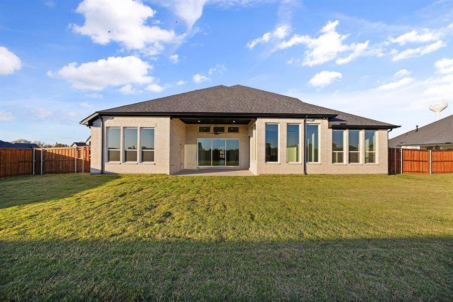 Back of property featuring a patio area, a fenced backyard, and roof with shingles Back of property featuring a patio area, a fenced backyard, and roof with shingles