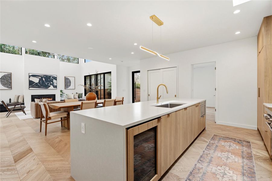 Large kitchen island with wood pannelled appliances