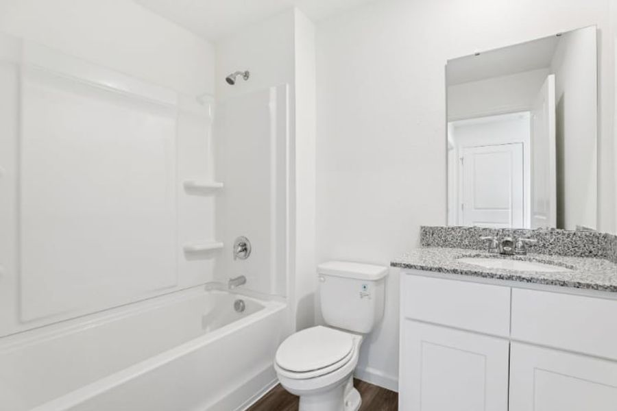 A bathroom with a tub toilet and sink.