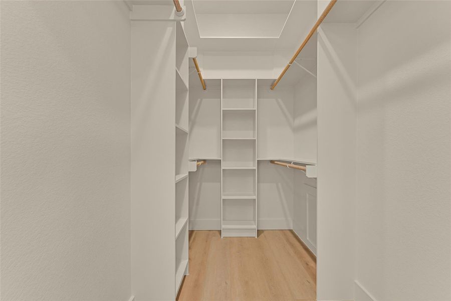 Primary walk in closet has 3 tiers and built in shelving. Primary walk in closet has 3 tiers and built in shelving.