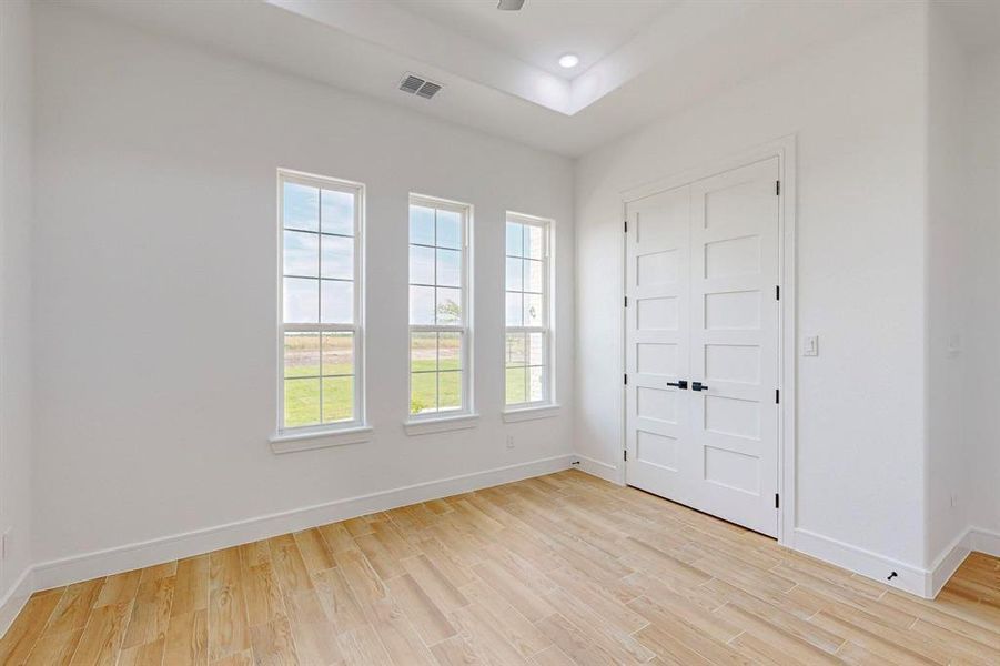 Unfurnished bedroom featuring light hardwood / wood-style flooring and a closet