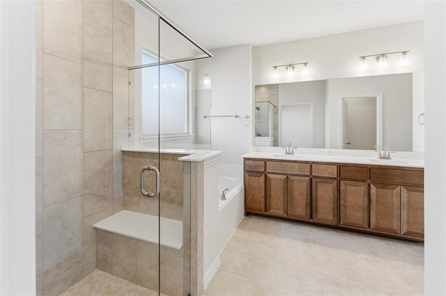 Bathroom with a garden tub, a stall shower, and double vanity Bathroom with a garden tub, a stall shower, and double vanity