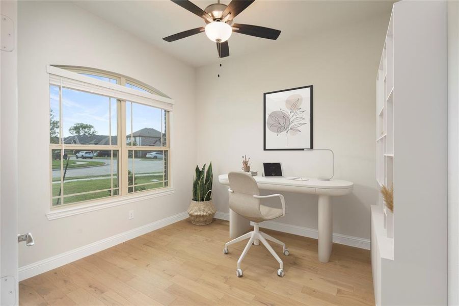 Office area with a water view, light wood-type flooring, and ceiling fan