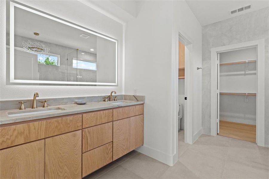 Bathroom with double vanity, a walk in closet, tile patterned flooring, and a shower Bathroom with double vanity, a walk in closet, tile patterned flooring, and a shower