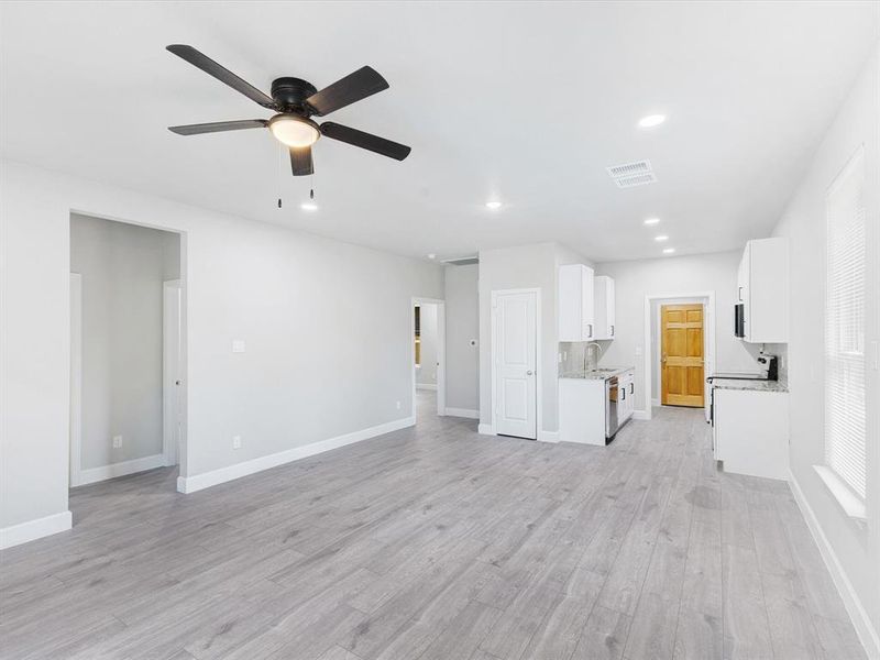 Unfurnished living room featuring recessed lighting, a ceiling fan, and light wood-style floors