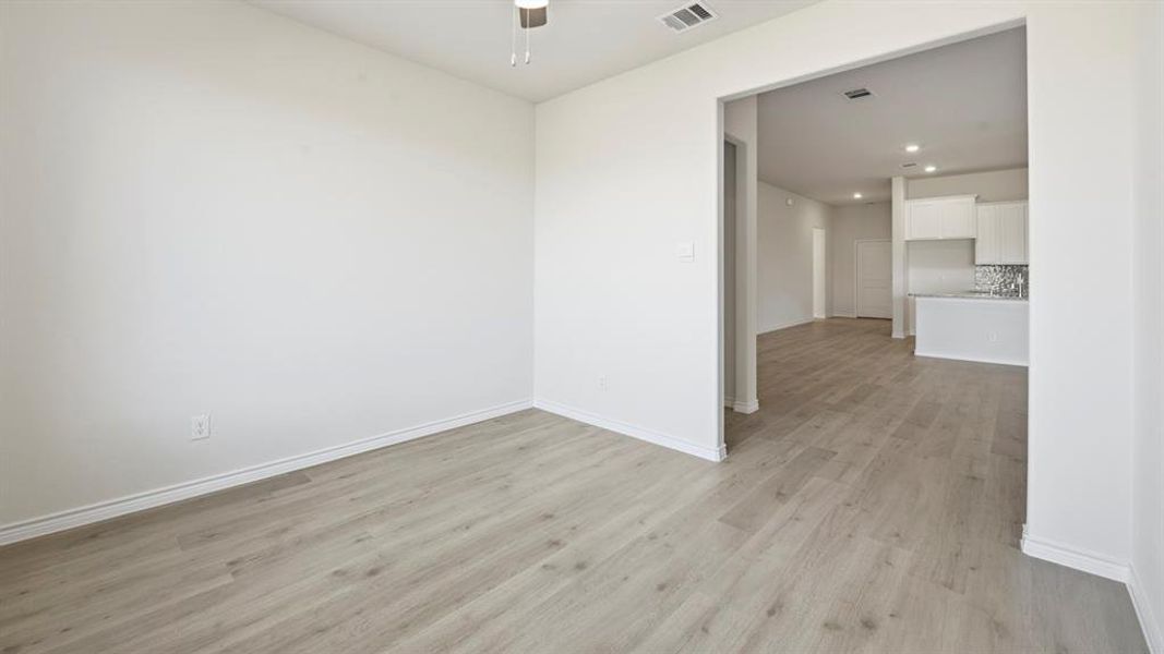 Spare room featuring light wood-type flooring, recessed lighting, and a ceiling fan