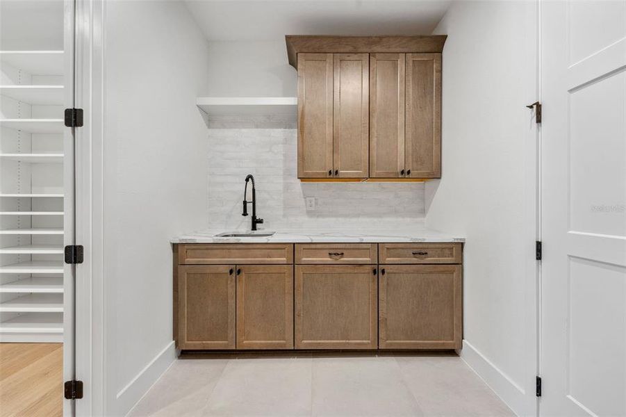 laundry room with hall and owners closet entry