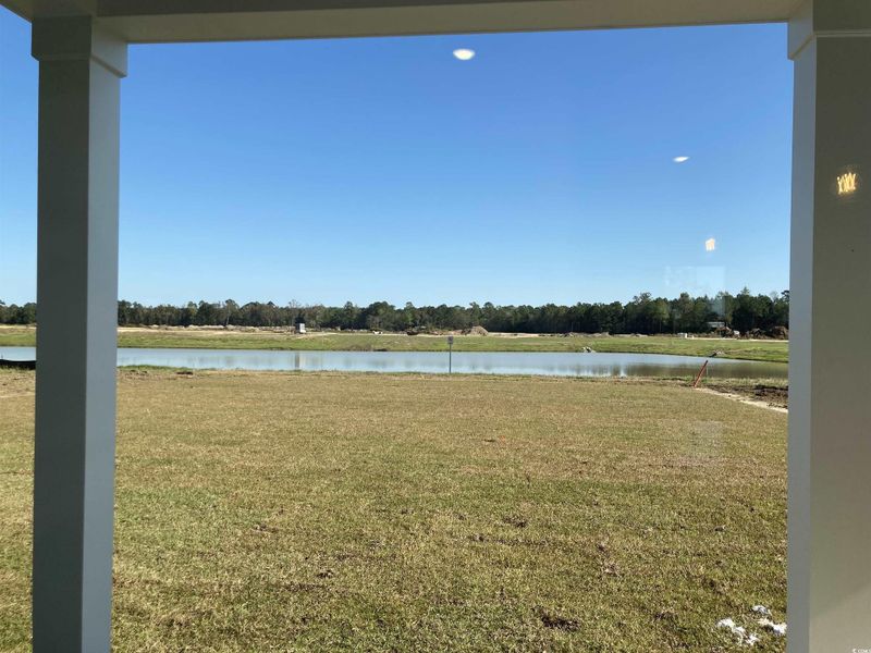 View of green lawn featuring a water view