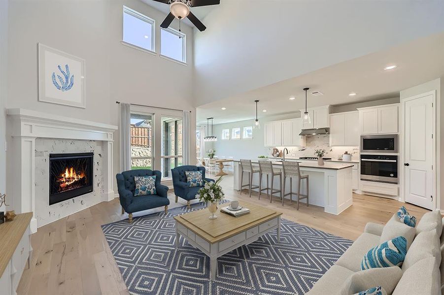 VIRTUALLY STAGED PHOTO - Living room featuring plenty of natural light, a fireplace, and light hardwood / wood-style flooring