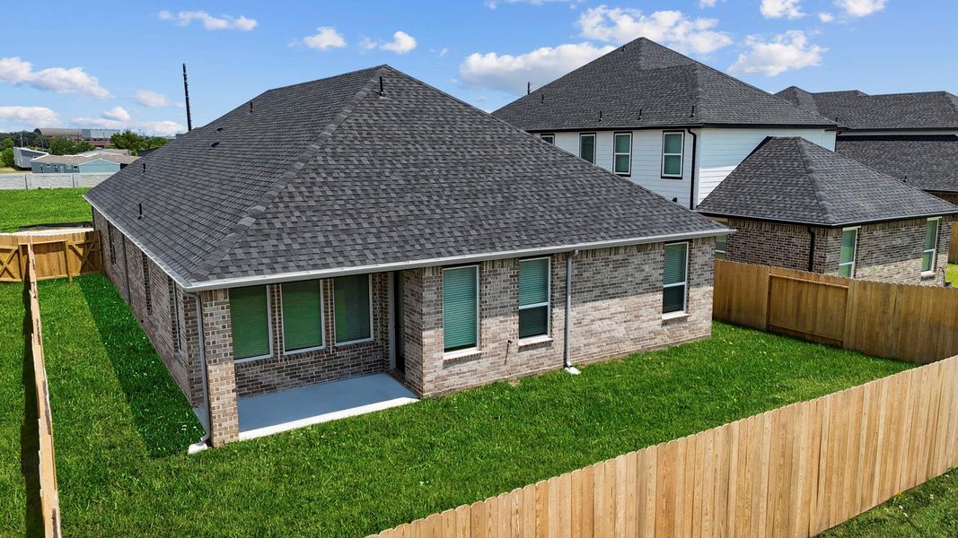 An aerial view of the backyard with the covered patio and fenced in backyard An aerial view of the backyard with the covered patio and fenced in backyard