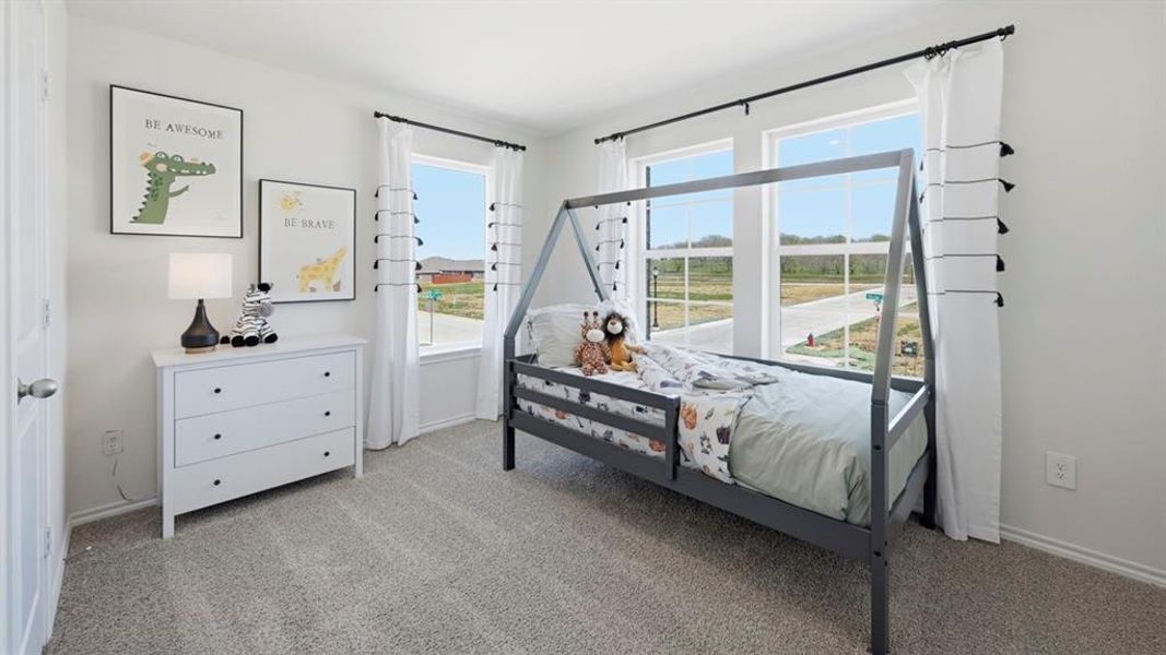 Bedroom with light colored carpet and baseboards Bedroom with light colored carpet and baseboards