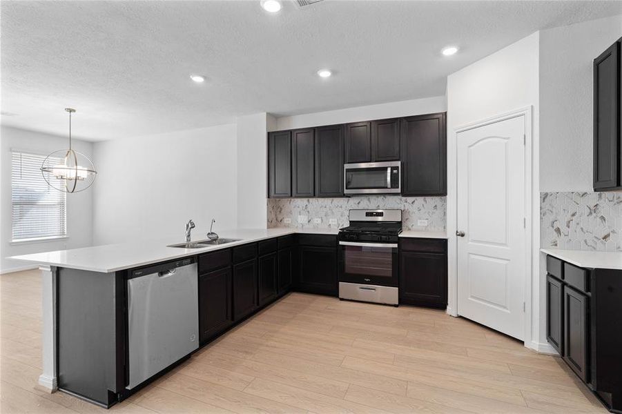 This kitchen is by far any chef’s dream! This spacious kitchen features high ceilings, stained wood cabinets, silestone countertops, SS appliances, modern tile backsplash, recessed lighting, extended counter space, and extended counter for breakfast bar, and a pantry all overlooking your huge family room.