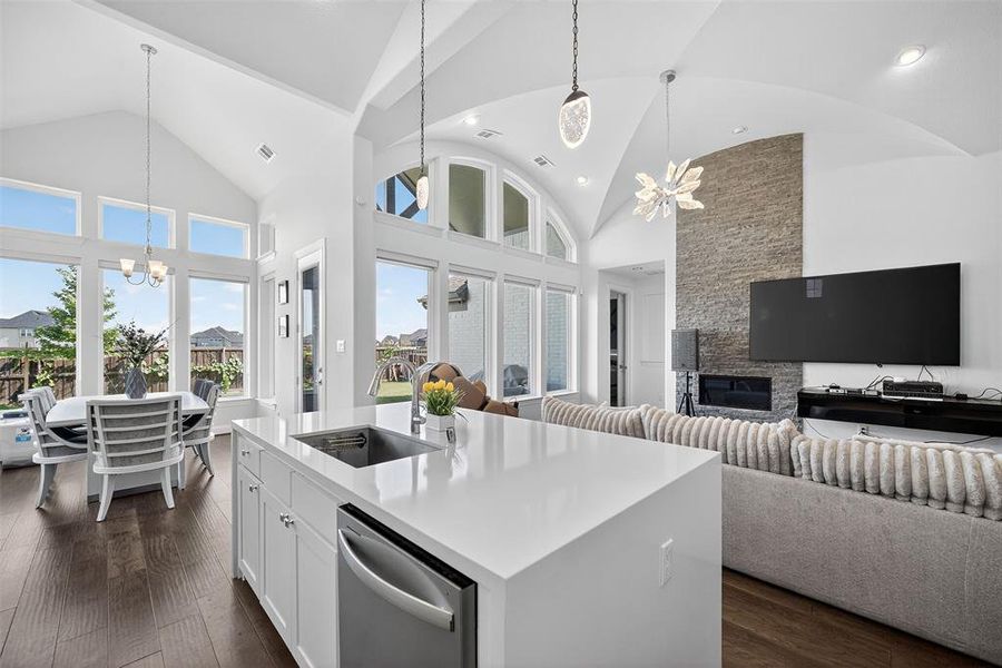 Kitchen with a chandelier, hanging light fixtures, open floor plan, high vaulted ceiling, and recessed lighting Kitchen with a chandelier, hanging light fixtures, open floor plan, high vaulted ceiling, and recessed lighting