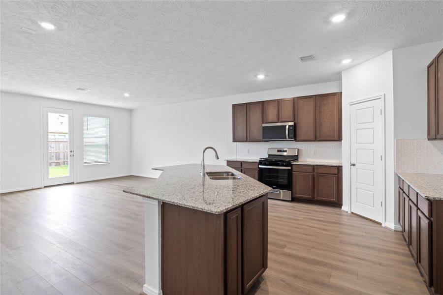 Upon entering the Great Room - views of the kitchen and dining area capture your attention.