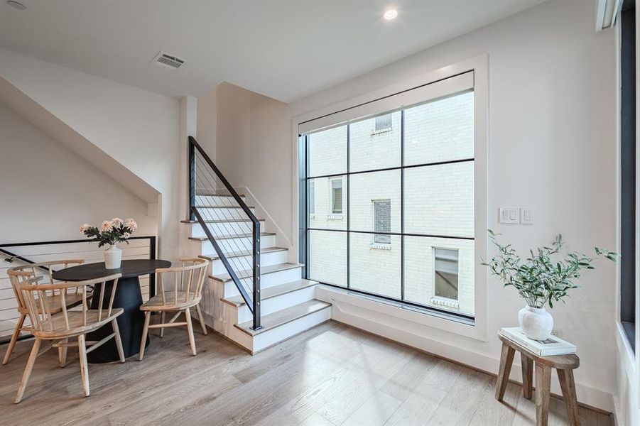 Staircase with wood finished floors and baseboards