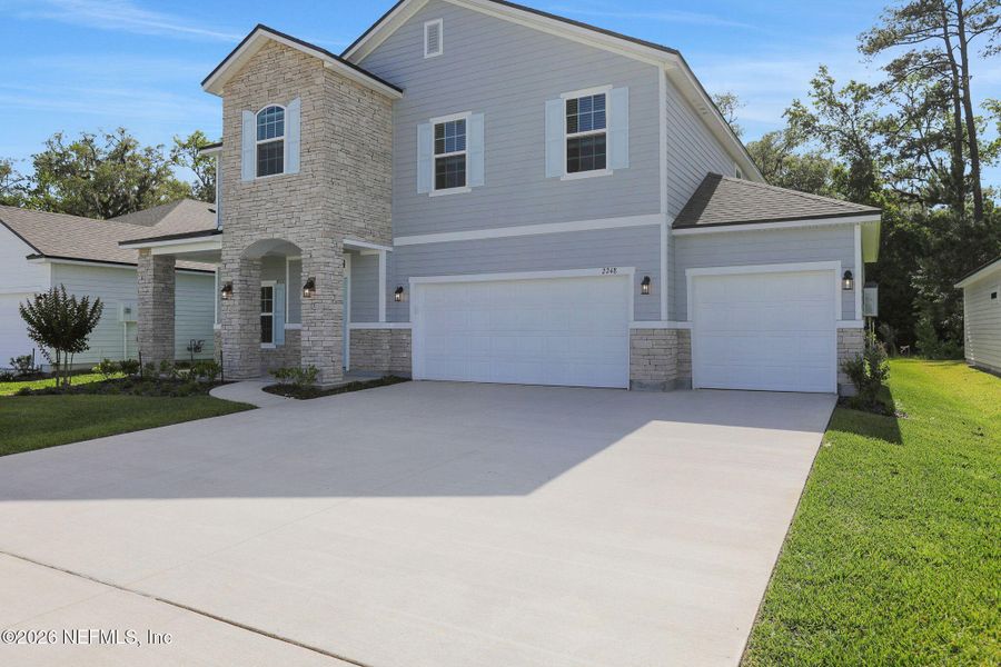 Front exterior of a new home in Jennings Farm, Middleburg, FL, highlighting curb appeal (Image 26). Front exterior of a new home in Jennings Farm, Middleburg, FL, highlighting curb appeal (Image 26).