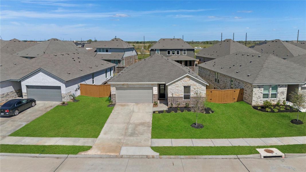 Front exterior of a new home in Emberly: Watermill Collection, Beasley, TX, highlighting curb appeal (Image 20).