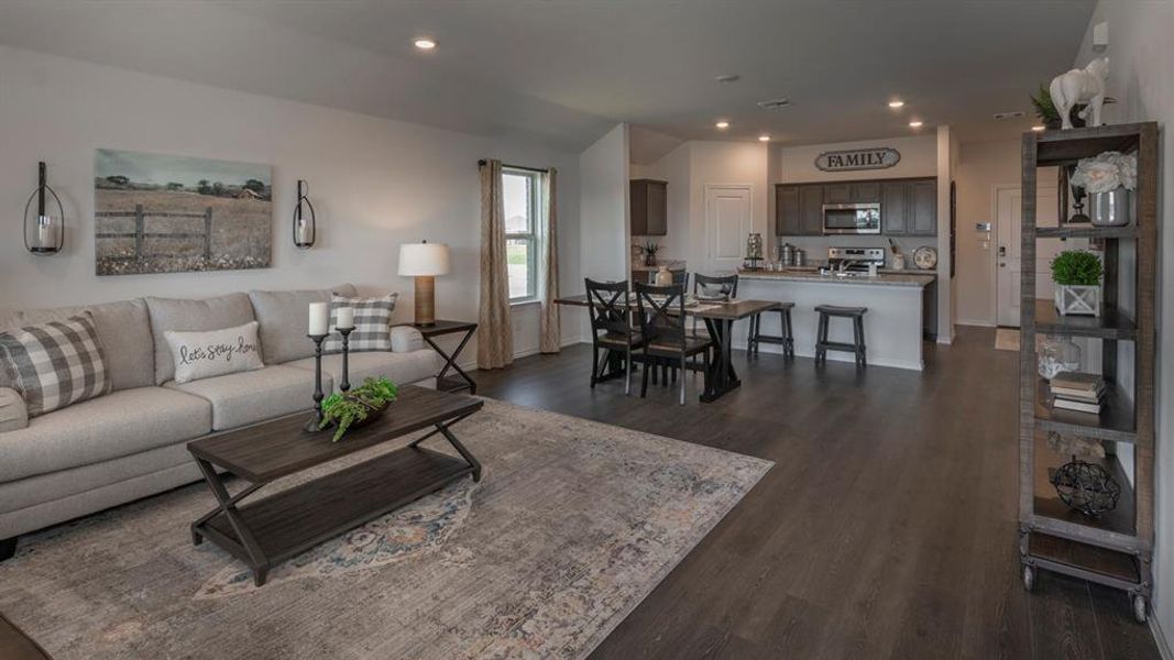 Living area featuring recessed lighting and dark wood-type flooring