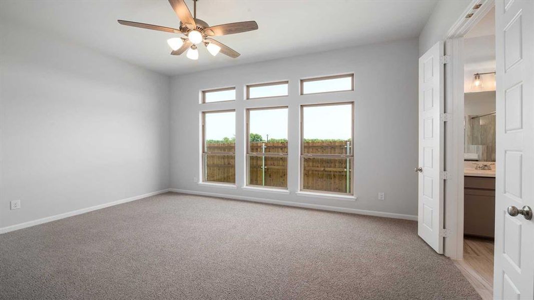 Unfurnished room featuring light colored carpet and ceiling fan