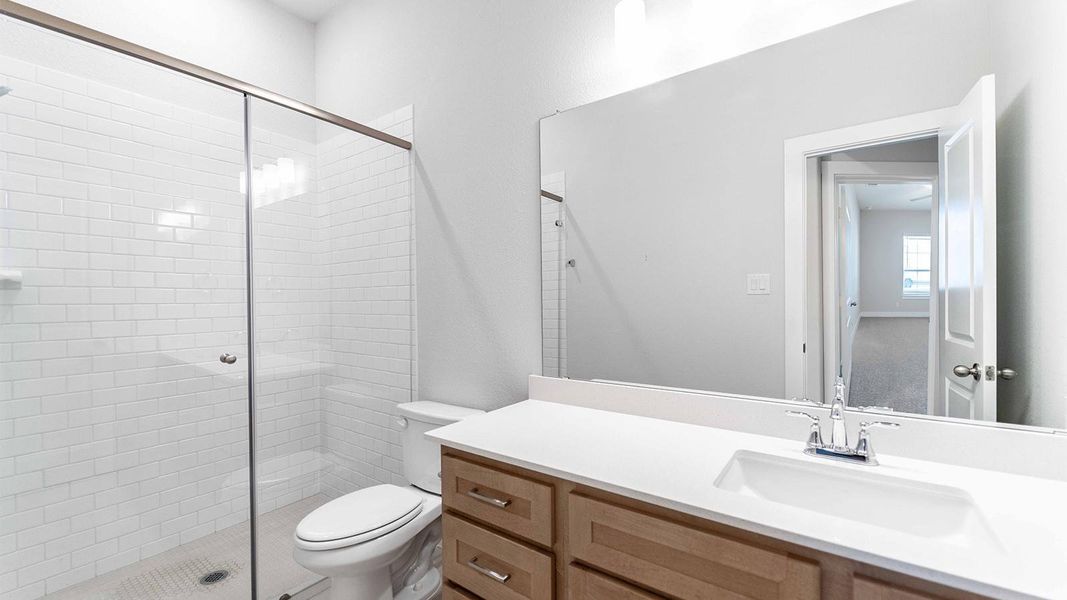 Bathroom featuring vanity and a shower stall Bathroom featuring vanity and a shower stall