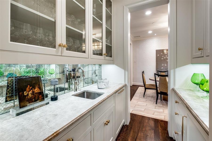 The butler's pantry/bar with lovely mirrored backsplash, sink, wine cooler and Miele dishwasher