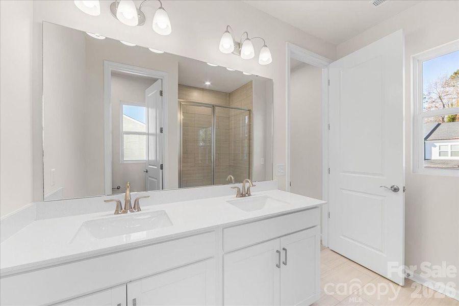Dual Vanity Primary Bathroom with White Clean Lines