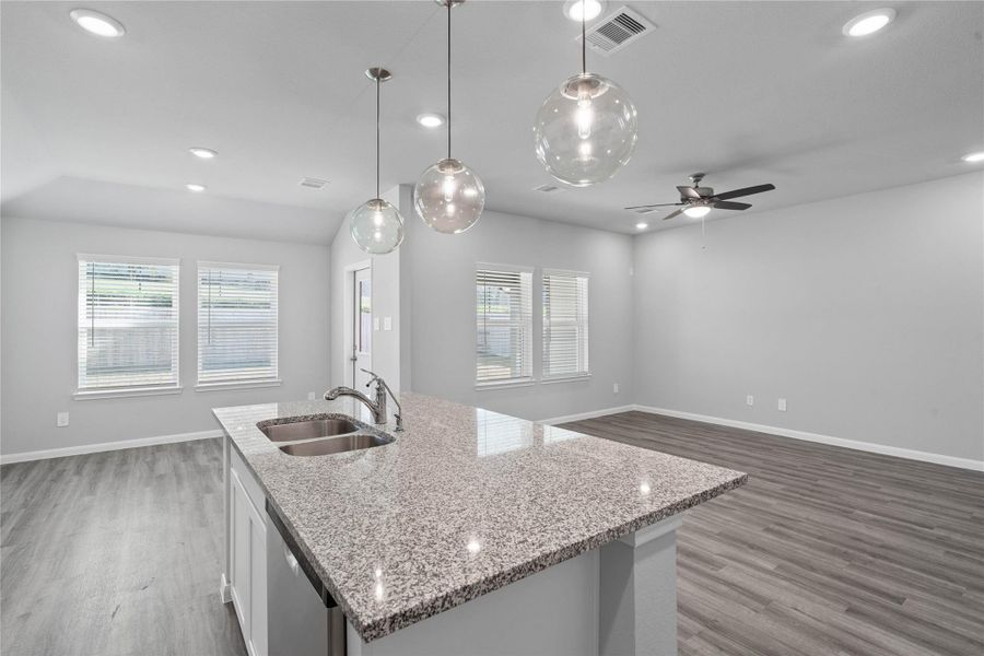 From the expansive kitchen island, enjoy seamless sightlines across the open-concept dining and living areas, making entertaining a breeze and ensuring you're never far from the conversation. From the expansive kitchen island, enjoy seamless sightlines across the open-concept dining and living areas, making entertaining a breeze and ensuring you're never far from the conversation.