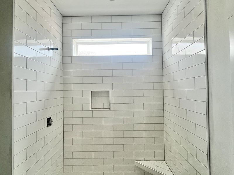 Your shower and glossy large subway tiles.