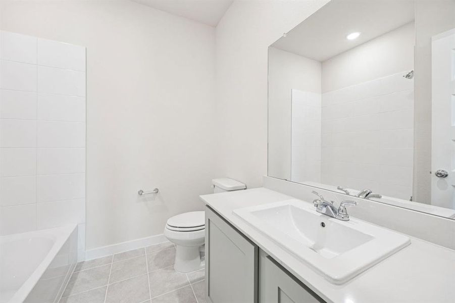 Bathroom in the Claret home plan by Trophy Signature Homes  REPRESENTATIVE PHOTO