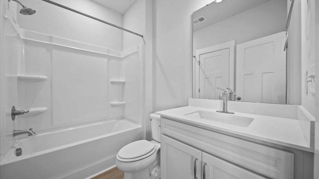 Vibrant and welcoming basement bathroom with elegant countertop space and polished details