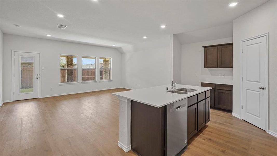 Open-concept living space with wood-finish flooring