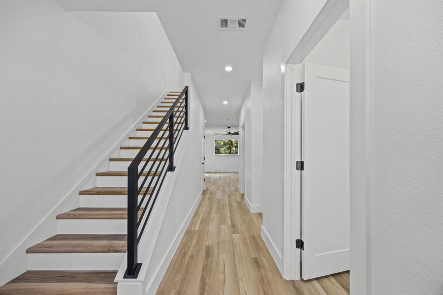 Hallway featuring recessed lighting, light wood-type flooring, and stairway