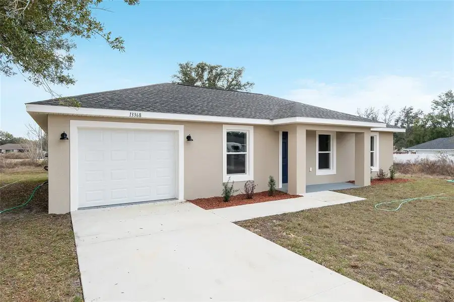Front exterior of a new home in , Ocala, FL, highlighting curb appeal (Image 1). Front exterior of a new home in , Ocala, FL, highlighting curb appeal (Image 1).