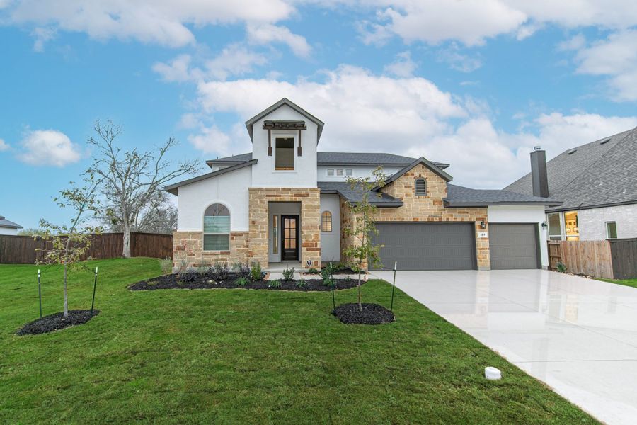 Front exterior of a new home in The Reserve at Potranco Oaks, Castroville, TX, highlighting curb appeal (Image 24).