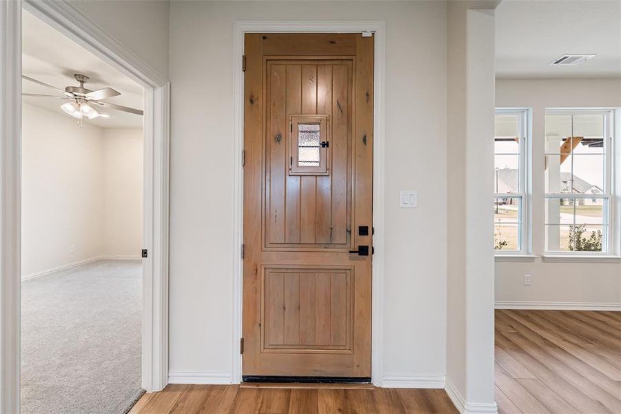 Foyer entrance with light wood-style flooring and a ceiling fan