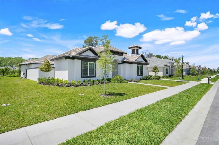 Front exterior of a new home in Toscana, Palm Coast, FL, highlighting curb appeal (Image 22).