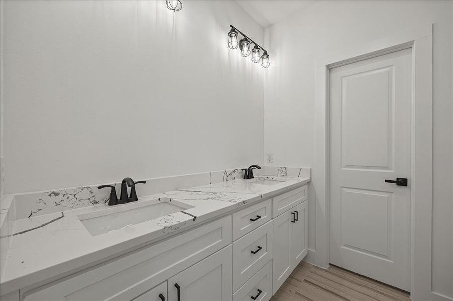 Full bath featuring double vanity