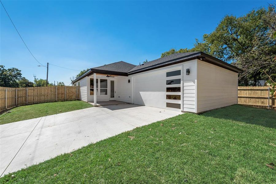 View of front facade with a patio and a front lawn