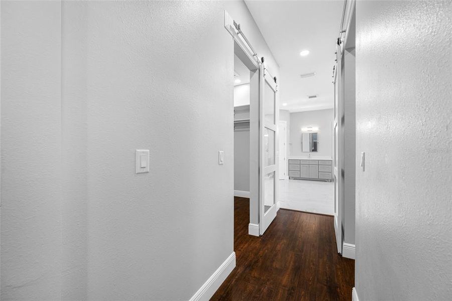 Primary hallway leading to his/hers closets and spa bath