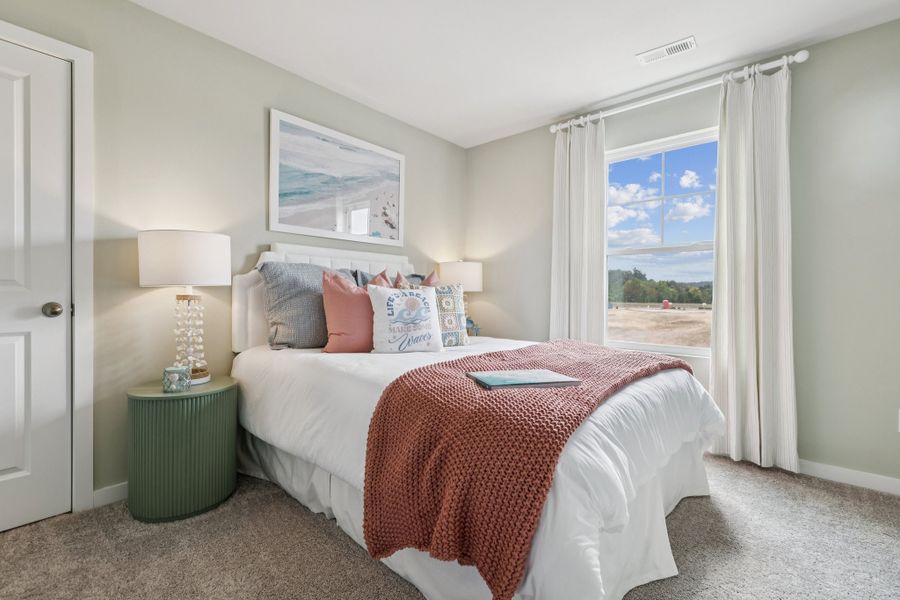 A bedroom with a large window.