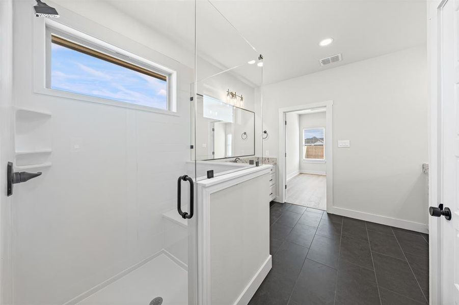 Full bathroom with vanity, a stall shower, dark tile patterned floors, and recessed lighting
