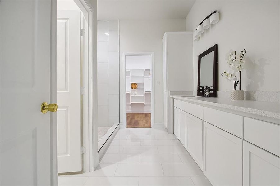 Bathroom with vanity, tile patterned floors, and walk in shower