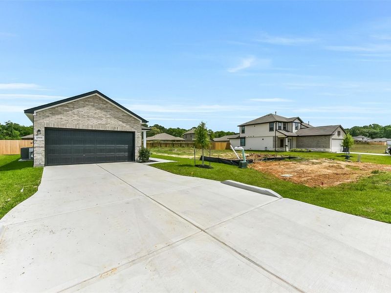 Front exterior of a new home in Liberty Estates, Cleveland, TX, highlighting curb appeal (Image 27).
