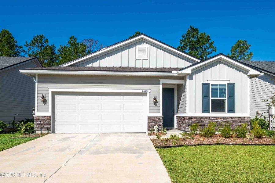 Front exterior of a new home in Tributary, Yulee, FL, highlighting curb appeal (Image 21). Front exterior of a new home in Tributary, Yulee, FL, highlighting curb appeal (Image 21).