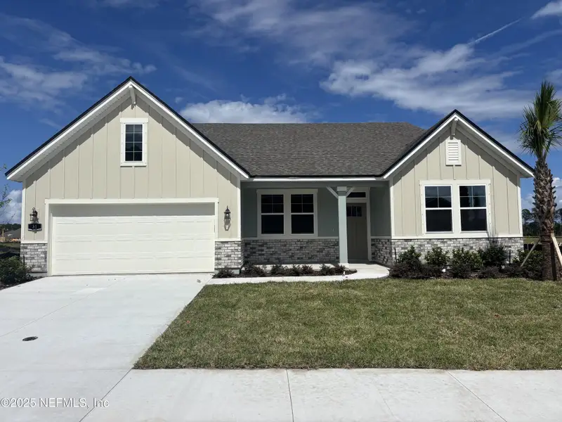 Front exterior of a new home in The Cypress Series at Reserve East, Flagler Beach, FL, highlighting curb appeal (Image 15).