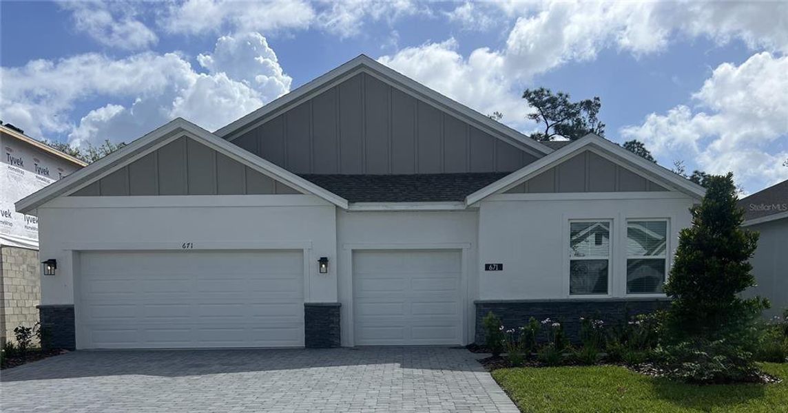 Front exterior of a new home in Trinity Gardens, Deland, FL, highlighting curb appeal (Image 1). Front exterior of a new home in Trinity Gardens, Deland, FL, highlighting curb appeal (Image 1).